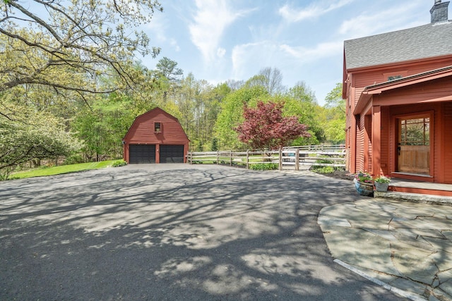 70 Cider Hill Rd, York, ME 03909 - view of property exterior featuring a detached garage, a barn, an outdoor structure, and a chimney