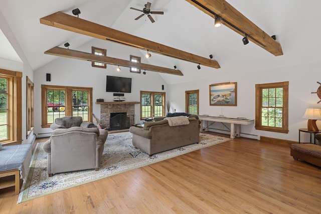 70 Cider Hill Rd, York, ME 03909 - living room with rail lighting, beam ceiling, a brick fireplace, a baseboard heating unit, and wood finished floors
