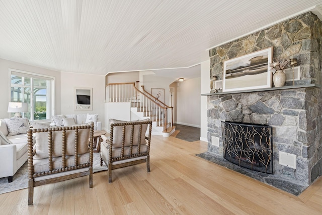 25 Ocean Ave, Cape Elizabeth, ME 04107 - living area with wood finished floors, stairway, a stone fireplace, and baseboards