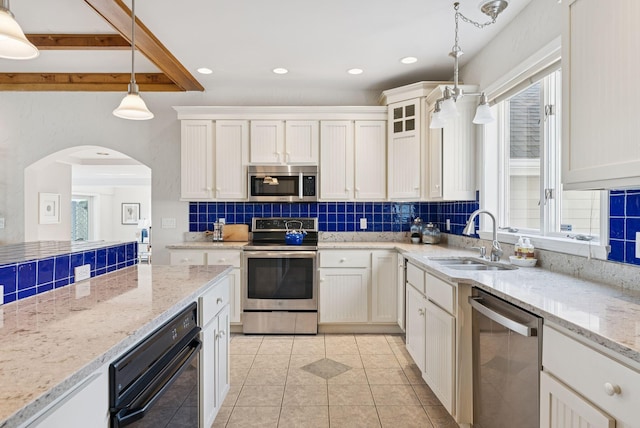 25 Ocean Ave, Cape Elizabeth, ME 04107 - kitchen featuring stainless steel appliances, backsplash, a sink, light tile patterned floors, and white cabinetry