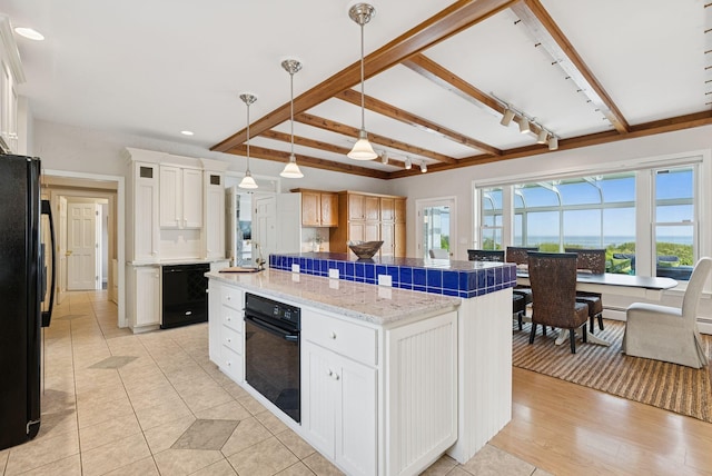 25 Ocean Ave, Cape Elizabeth, ME 04107 - kitchen featuring black appliances, a kitchen island, white cabinets, decorative light fixtures, and beam ceiling