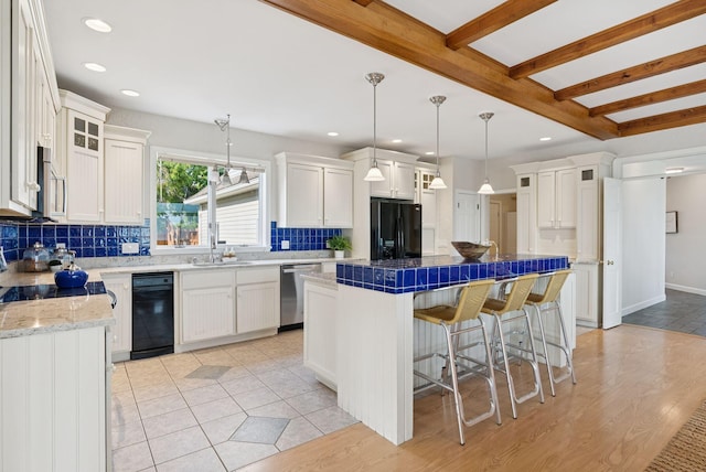 25 Ocean Ave, Cape Elizabeth, ME 04107 - kitchen featuring stainless steel appliances, decorative backsplash, white cabinets, a center island, and a sink