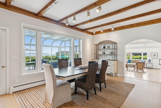 25 Ocean Ave, Cape Elizabeth, ME 04107 - dining space featuring a baseboard radiator, arched walkways, beam ceiling, rail lighting, and light wood-style flooring
