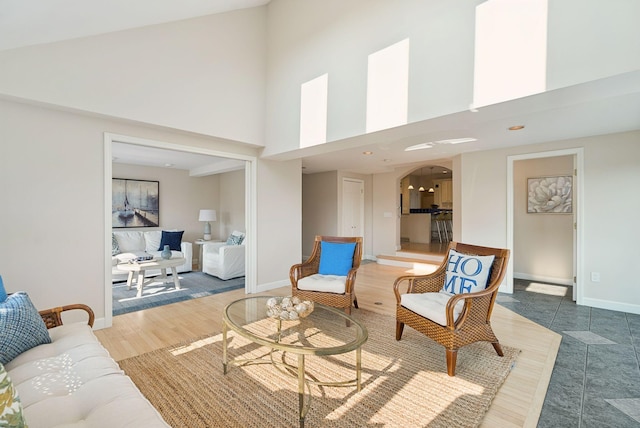 25 Ocean Ave, Cape Elizabeth, ME 04107 - living area with a towering ceiling, arched walkways, and baseboards