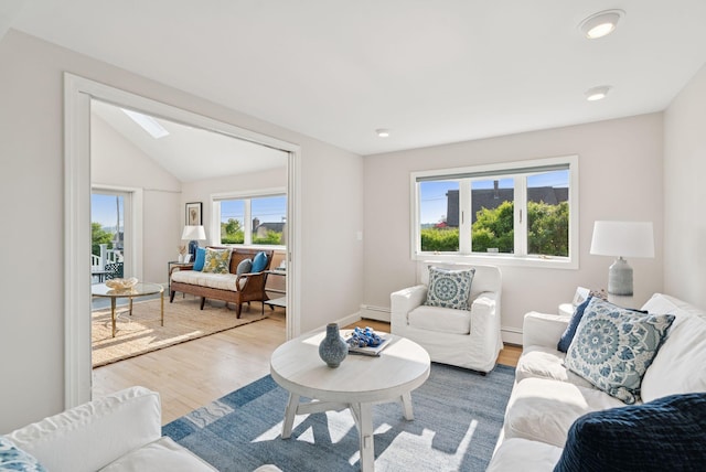 25 Ocean Ave, Cape Elizabeth, ME 04107 - living area with a baseboard heating unit, wood finished floors, a skylight, and lofted ceiling