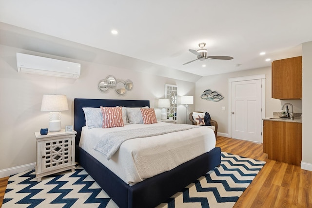 25 Ocean Ave, Cape Elizabeth, ME 04107 - bedroom with a wall unit AC, light wood finished floors, baseboards, and recessed lighting
