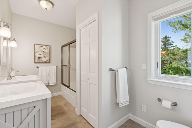 25 Ocean Ave, Cape Elizabeth, ME 04107 - full bathroom with double vanity, baseboards, bath / shower combo with glass door, and toilet