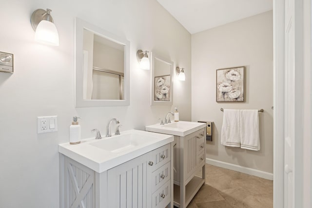 25 Ocean Ave, Cape Elizabeth, ME 04107 - bathroom featuring two vanities and baseboards