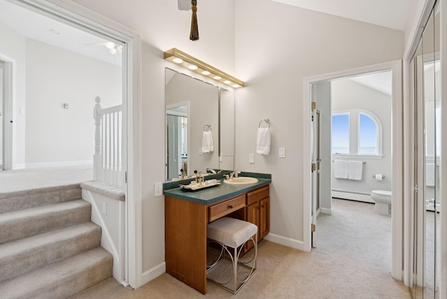 25 Ocean Ave, Cape Elizabeth, ME 04107 - full bath with lofted ceiling, vanity, a baseboard heating unit, toilet, and baseboards