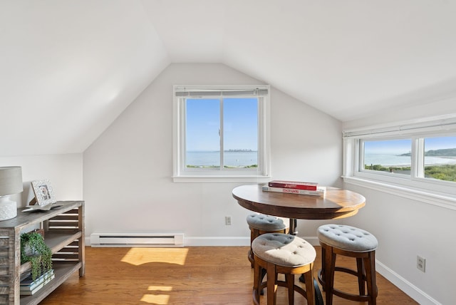 25 Ocean Ave, Cape Elizabeth, ME 04107 - dining space with a baseboard heating unit, vaulted ceiling, wood finished floors, and baseboards