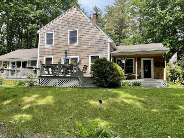 282 Pierces Point Rd, Windsor, ME 04363 - back of property featuring a chimney, a yard, roof with shingles, and a wooden deck