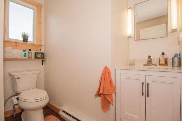 42 Old Mill Rd, Bristol, ME 04554 - bathroom featuring vanity, toilet, baseboard heating, and baseboards