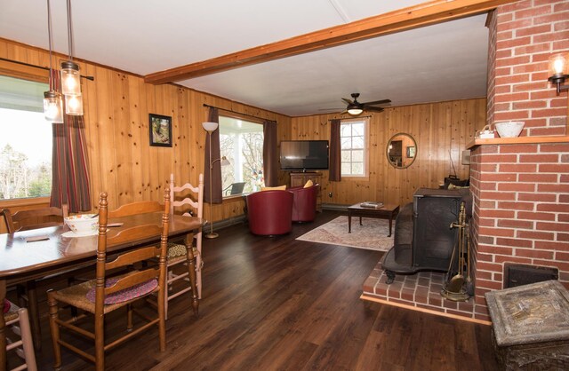 42 Old Mill Rd, Bristol, ME 04554 - dining space featuring a wood stove, wooden walls, wood finished floors, ceiling fan, and beamed ceiling