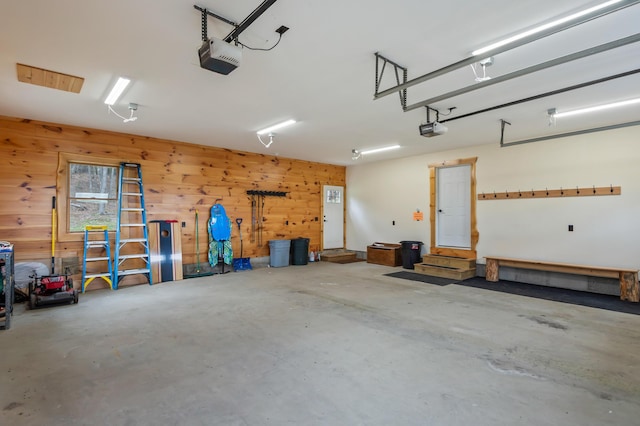3935 Main St, Rangeley, ME 04970 - garage featuring a garage door opener and wooden walls