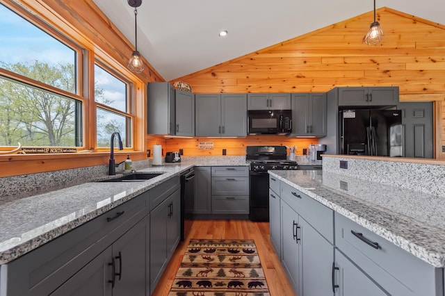 3935 Main St, Rangeley, ME 04970 - kitchen with black appliances, vaulted ceiling, a sink, light wood-style flooring, and gray cabinets