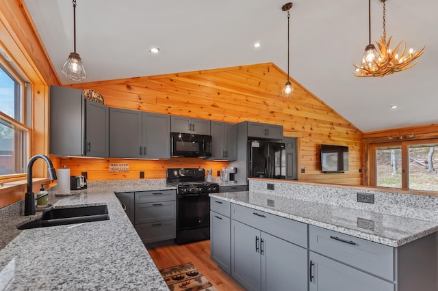 3935 Main St, Rangeley, ME 04970 - kitchen with black appliances, a sink, lofted ceiling, gray cabinetry, and wooden walls