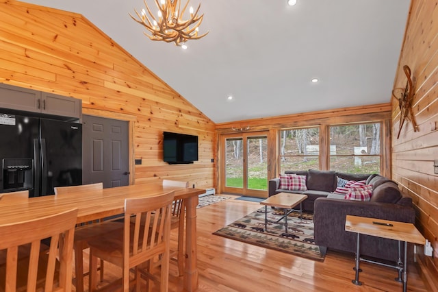 3935 Main St, Rangeley, ME 04970 - dining area with wood walls, a chandelier, light wood finished floors, high vaulted ceiling, and recessed lighting