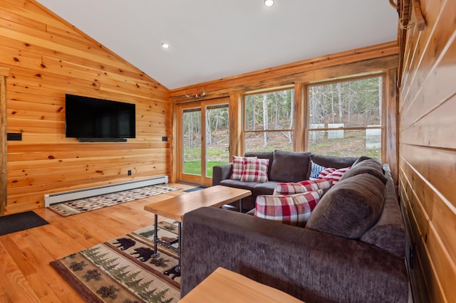 3935 Main St, Rangeley, ME 04970 - living area with a baseboard radiator, lofted ceiling, wood finished floors, wood walls, and recessed lighting