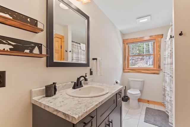 3935 Main St, Rangeley, ME 04970 - bathroom with vanity, toilet, and baseboards