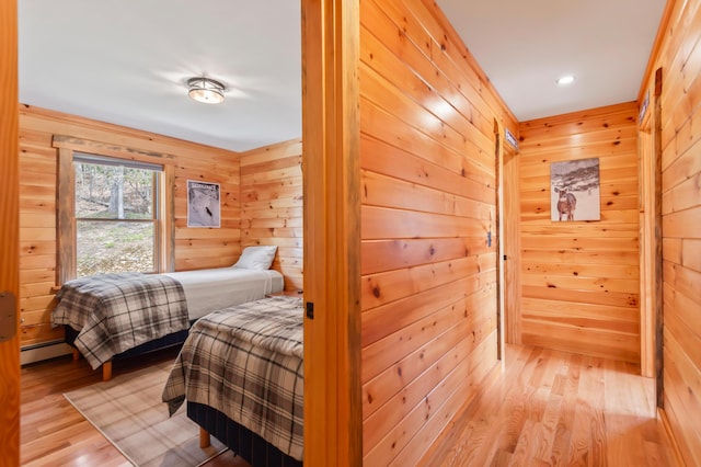 3935 Main St, Rangeley, ME 04970 - bedroom featuring baseboard heating, wood walls, light wood-style flooring, and recessed lighting