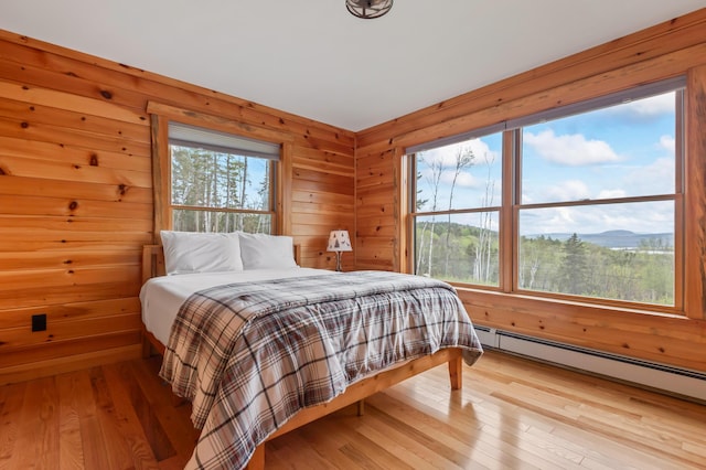 3935 Main St, Rangeley, ME 04970 - bedroom featuring baseboard heating, hardwood / wood-style floors, and wooden walls