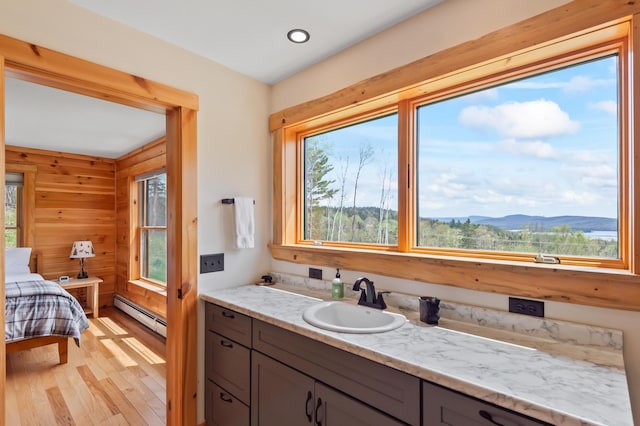 3935 Main St, Rangeley, ME 04970 - bathroom with baseboard heating, plenty of natural light, wood finished floors, a mountain view, and recessed lighting