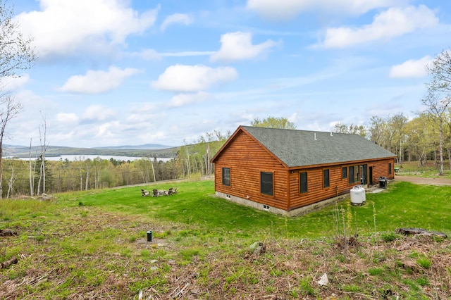 3935 Main St, Rangeley, ME 04970 - view of property exterior with a water view, roof with shingles, and a yard
