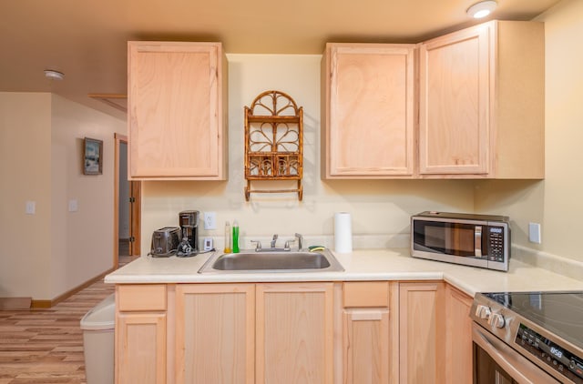 22 Partridge Ln, Medford, ME 04463 - kitchen featuring light brown cabinets, a sink, appliances with stainless steel finishes, light wood finished floors, and light countertops