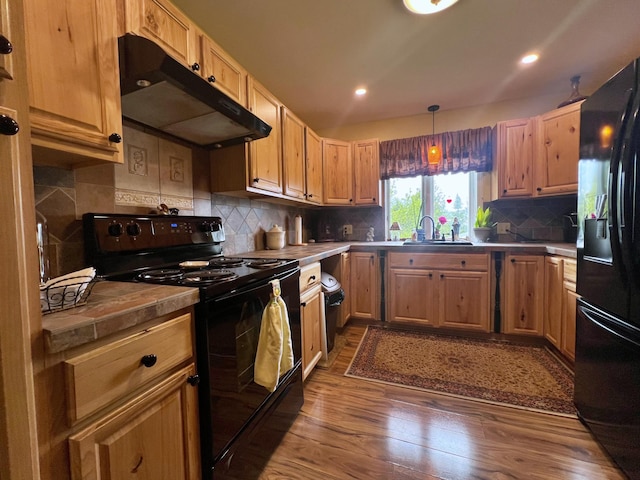 13 Pearl St, Fort Kent, ME 04743 - kitchen with black appliances, under cabinet range hood, dark wood-style floors, a sink, and backsplash