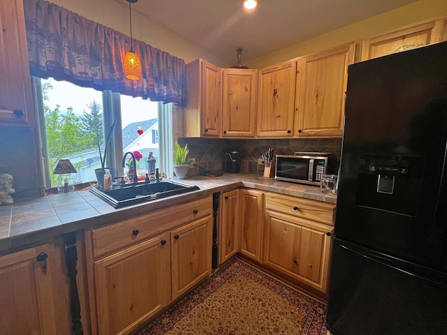 13 Pearl St, Fort Kent, ME 04743 - kitchen with black fridge, tile counters, stainless steel microwave, and a sink