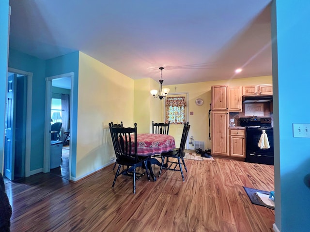 13 Pearl St, Fort Kent, ME 04743 - dining room with wood finished floors, a chandelier, and baseboards