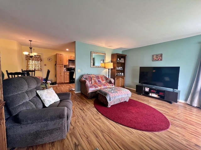 13 Pearl St, Fort Kent, ME 04743 - living area featuring a chandelier, wood finished floors, and baseboards