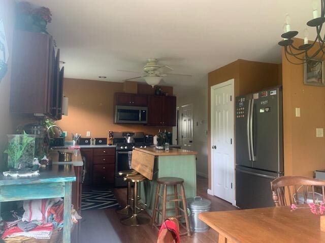 196 Lambert Rd, Brewer, ME 04412 - kitchen featuring appliances with stainless steel finishes, ceiling fan, dark wood-style flooring, a center island, and a sink