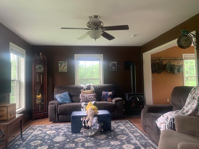 196 Lambert Rd, Brewer, ME 04412 - living area featuring a ceiling fan, wood finished floors, and a wood stove