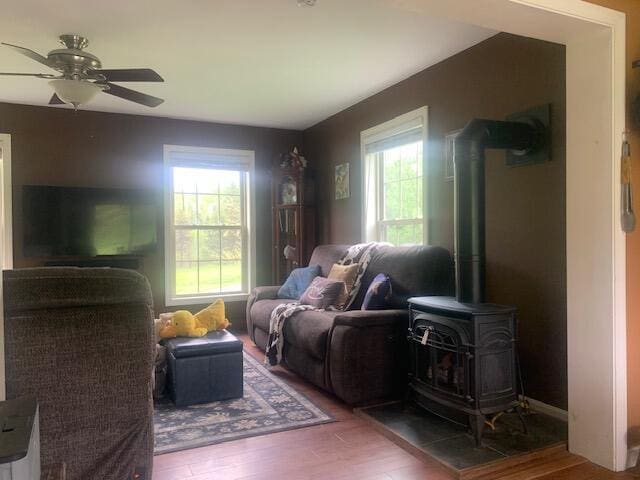 196 Lambert Rd, Brewer, ME 04412 - living room with wood finished floors, ceiling fan, and a wood stove