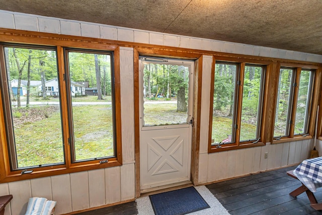 18 Julian St, Sebago, ME 04029 - entryway with wooden walls, dark wood-style flooring, and healthy amount of natural light