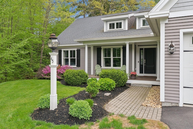 45 S Ridge Rd, Falmouth, ME 04105 - view of exterior entry with covered porch, a yard, and roof with shingles