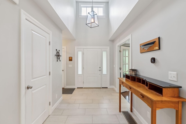 45 S Ridge Rd, Falmouth, ME 04105 - entryway featuring a towering ceiling, baseboards, and light tile patterned floors