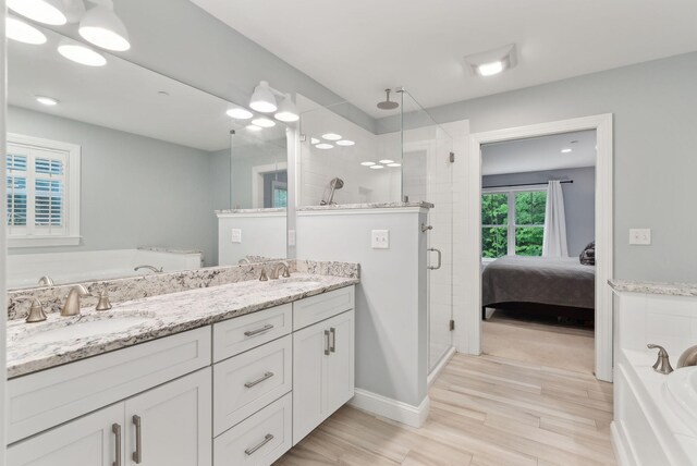 45 S Ridge Rd, Falmouth, ME 04105 - full bathroom featuring a shower stall, a garden tub, double vanity, and wood finished floors