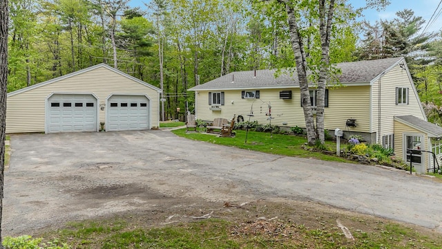 19 Rumery Rd, Lyman, ME 04002 - view of front of property with a detached garage, an outdoor structure, roof with shingles, and view of scattered trees