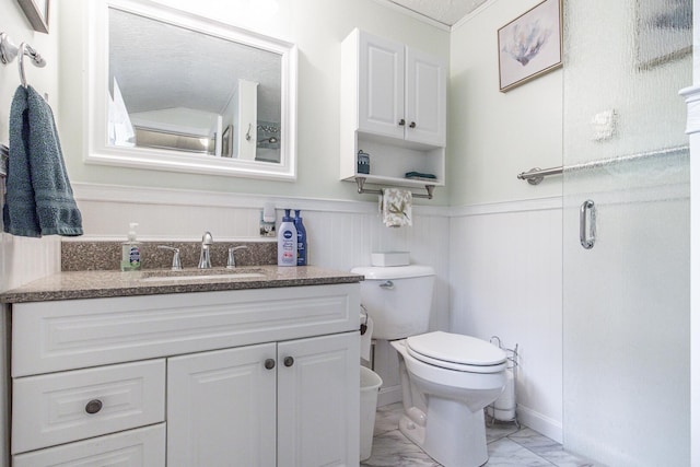 19 Rumery Rd, Lyman, ME 04002 - bathroom with marble finish flooring, vanity, toilet, a wainscoted wall, and crown molding