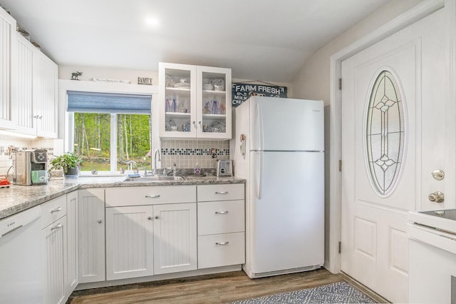 19 Rumery Rd, Lyman, ME 04002 - kitchen featuring white appliances, a sink, wood finished floors, tasteful backsplash, and white cabinets