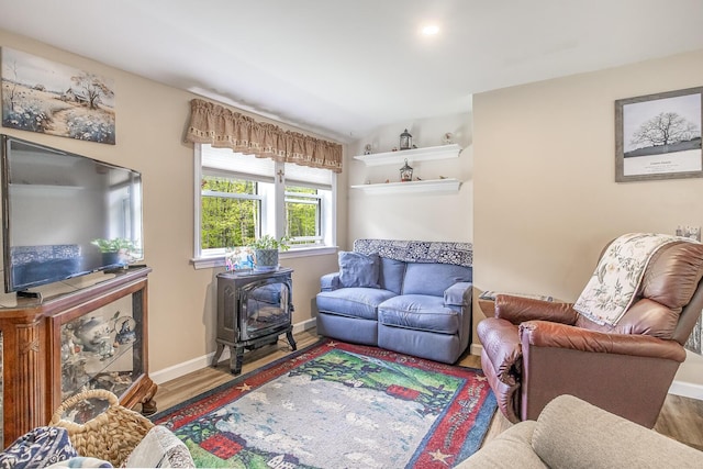 19 Rumery Rd, Lyman, ME 04002 - living area with a wood stove, wood finished floors, and baseboards