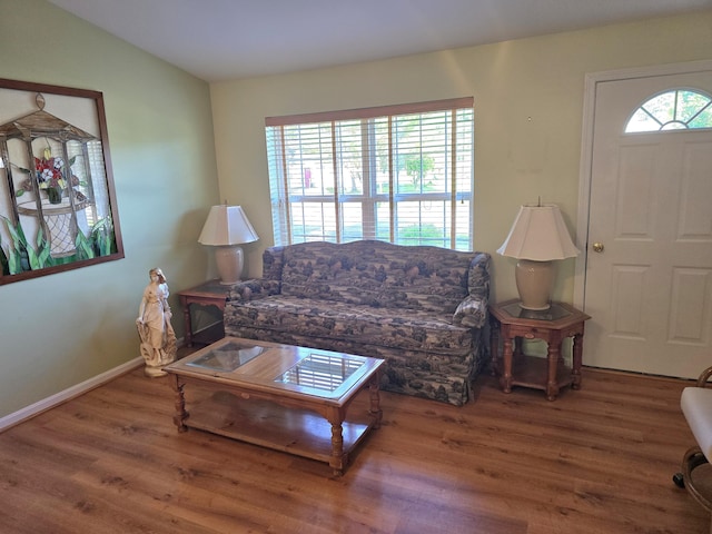 83 Clover Ln, Auburn, ME 04210 - living room with wood finished floors, baseboards, and lofted ceiling