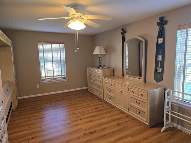 83 Clover Ln, Auburn, ME 04210 - bedroom with multiple windows, light wood finished floors, and baseboards