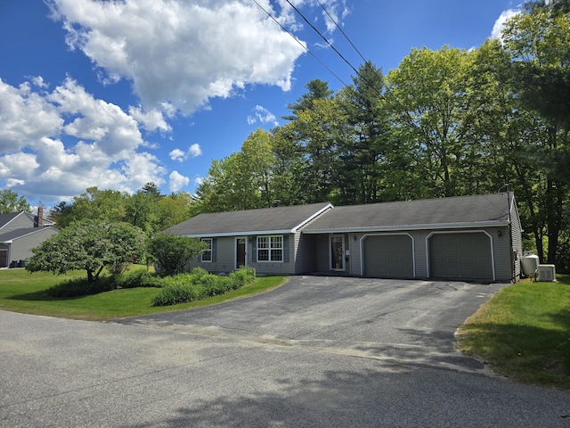 83 Clover Ln, Auburn, ME 04210 - single story home with an attached garage, driveway, a front yard, and central air condition unit