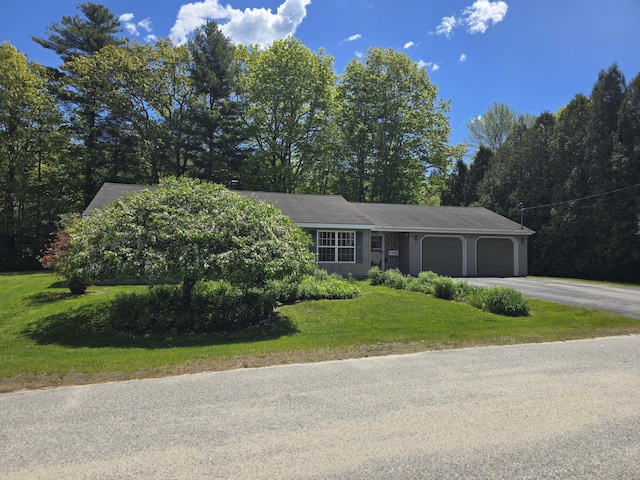 83 Clover Ln, Auburn, ME 04210 - view of front of home featuring an attached garage, asphalt driveway, and a front yard