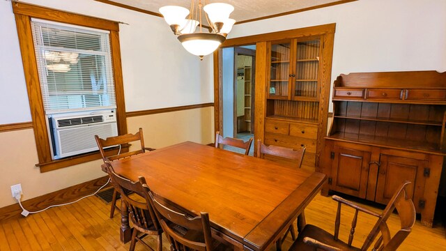 191 Bates St, Pittsfield, ME 04967 - dining area featuring a chandelier, crown molding, light wood-type flooring, and cooling unit