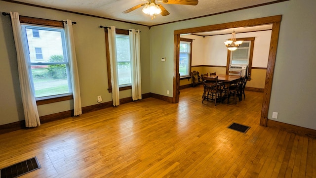 191 Bates St, Pittsfield, ME 04967 - unfurnished dining area with crown molding, light wood-style floors, a chandelier, ceiling fan, and cooling unit