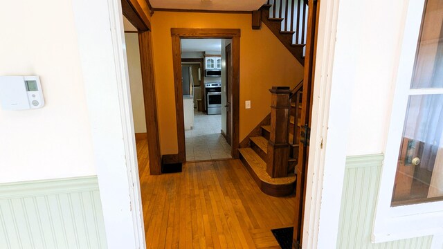 191 Bates St, Pittsfield, ME 04967 - hall featuring wainscoting, stairway, and wood finished floors